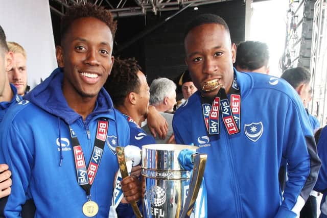 Jamal Lowe, left, holds the League Two trophy with team-mate Nicke Kabamba Picture: Joe Pepler