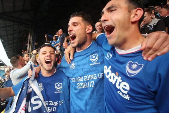 Conor Chaplin, s Gareth Evans and, Gary Roberts celebrate Pompey's League Two title win. Photo by Joe Pepler/