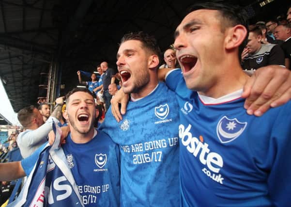 Conor Chaplin, s Gareth Evans and, Gary Roberts celebrate Pompey's League Two title win. Photo by Joe Pepler/