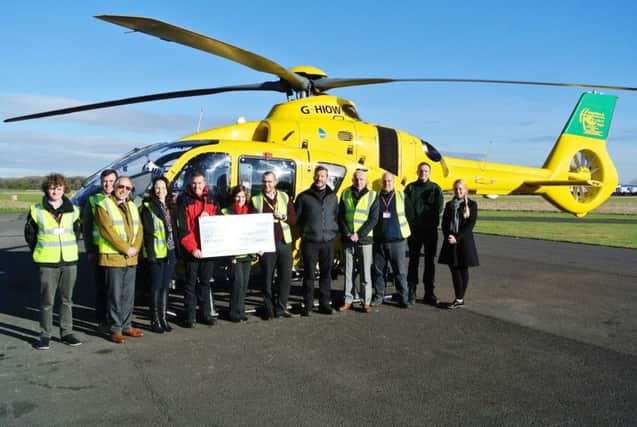 Volunteers accept a donation for HIOWAA