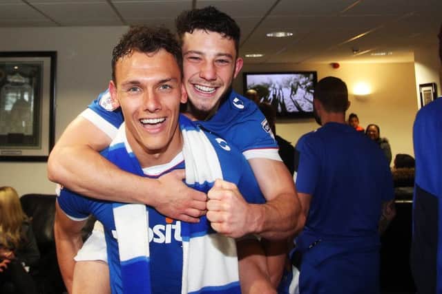 Kal Naismith celebrates Pompey's promotion with Conor Chapli. Picture: Joe Pepler