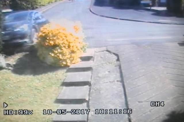 The runaway car mounts the kerb