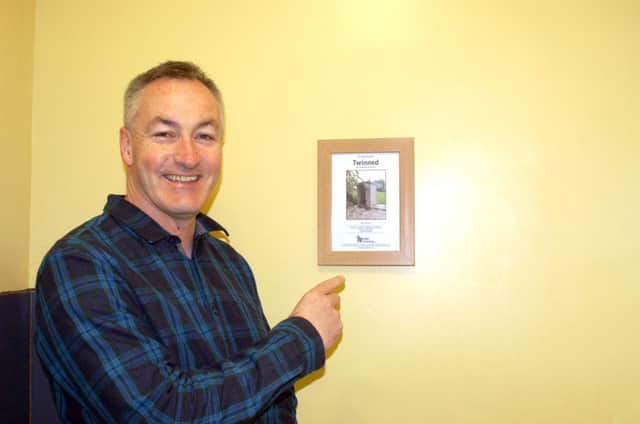Simon Ford, youth minister at Cosham Baptist Church, shows off their toilet twinning certificate