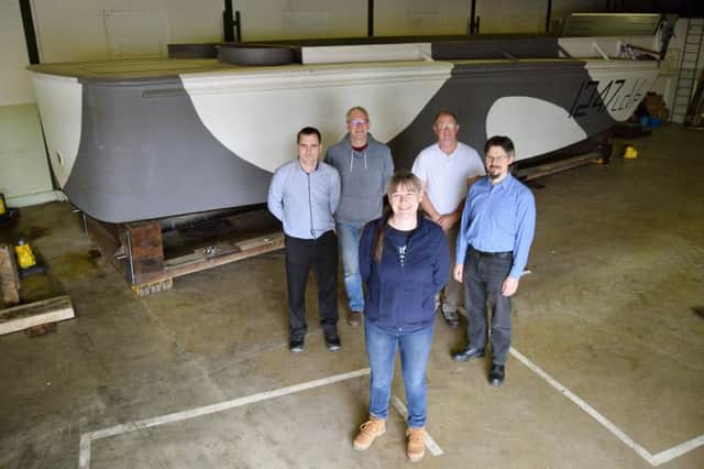 Back row: James Daly, collections researcher, Tim Gower, collections supervision, Nick Thompson, technologies assistant officers and Andrew Whitmarsh, development officer. Front is Katy Ball, collections registrar. They are pictured in front of Second World War landing craft, L247.