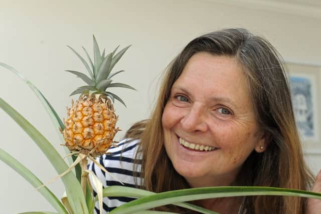 Tracey Aldridge with the pineapple she has grown in a pot at her home in Gosport Picture Ian Hargreaves  (170619-1)