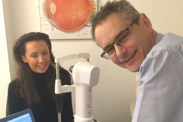 Optician Richard Candlin demonstrating Anne Gill Eyecares new technology