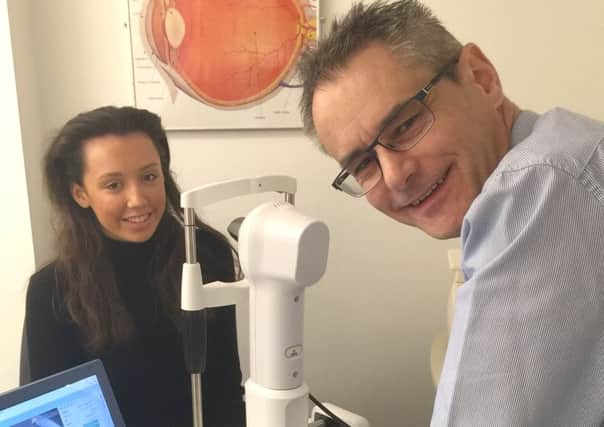 Optician Richard Candlin demonstrating Anne Gill Eyecares new technology