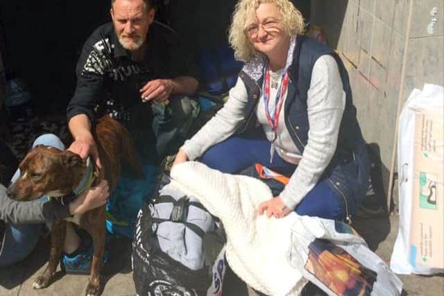 Volunteer Kim Price, right, with Ian and his dog Smudge
