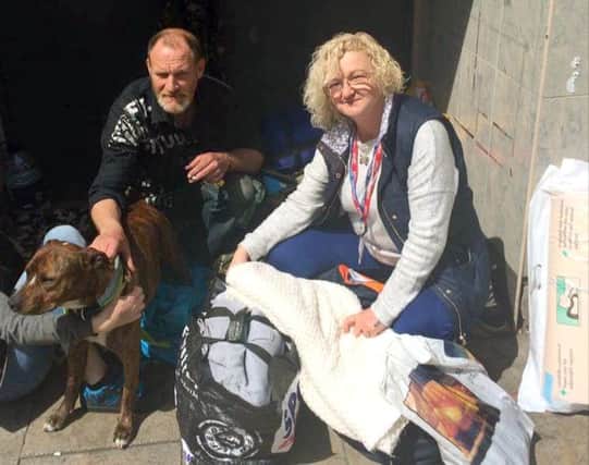 Volunteer Kim Price, right, with Ian and his dog Smudge