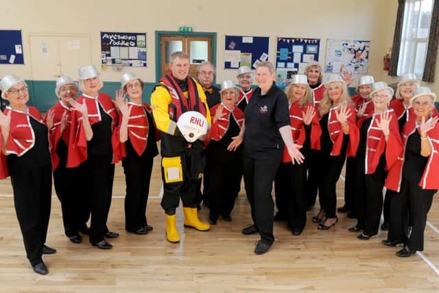 Reflections choir donate a cheque to Guy Rudkin and Jacqui Hutchins from Portsmouth RNLI