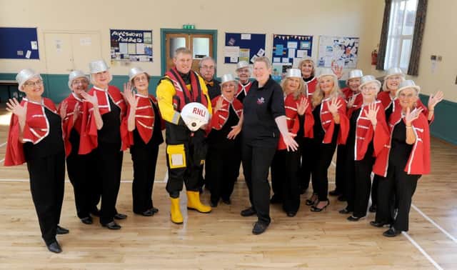 Reflections choir donate a cheque to Guy Rudkin and Jacqui Hutchins from Portsmouth RNLI