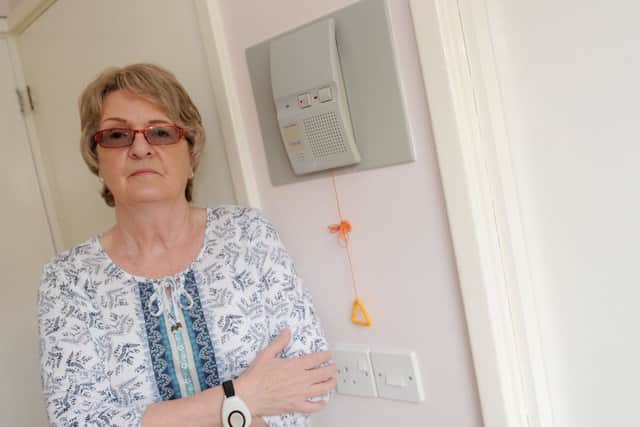 Cheryl Anderson next to her personal safety alarm