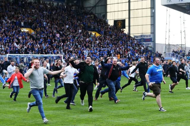 Fans celebrate Pompey's League Two triumph by invading Fratton Park. Picture: Joe Pepler