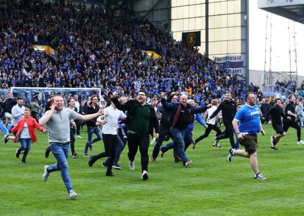 Fans celebrate Pompey's League Two triumph by invading Fratton Park. Picture: Joe Pepler