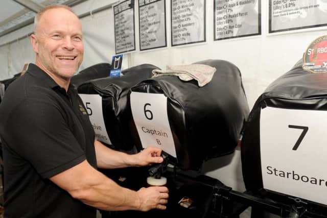 The Delme Arms  landlord Neil Matthews pulls pints Picture: Sarah Standing (170718-2724)