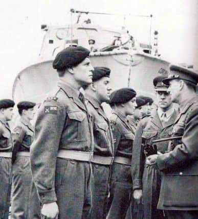 With Fast Launch Corranach in the background, soldiers of the armys  navy are inspected at Gunwharf, Portsmouth.