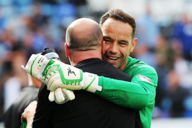 David Forde and Pompey boss Paul Cook. Picture: Joe Pepler