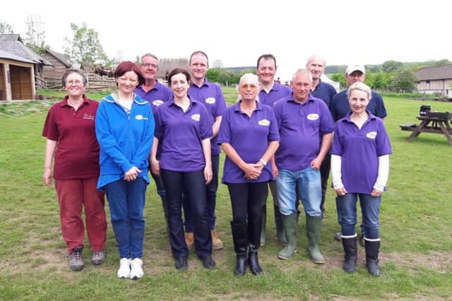 Employees from Pfizer with Sue Webber, left, from Butser Ancient Farm