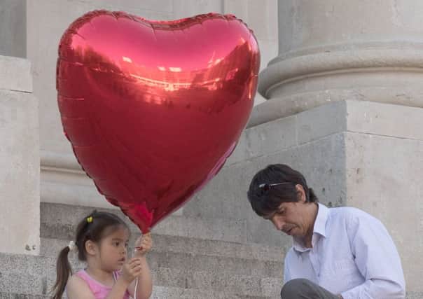 A little girl prepares to release a heart-shaped balloon during a vigil for the victims of the Manchester bombing on the steps of Portsmouth Guildhall. 

Picture Keith Woodland (170679-005)