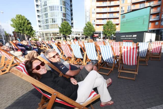 Katrina Arens and David Ellis enjoy the America's Cup action on the big screen at Gunwharf Quays