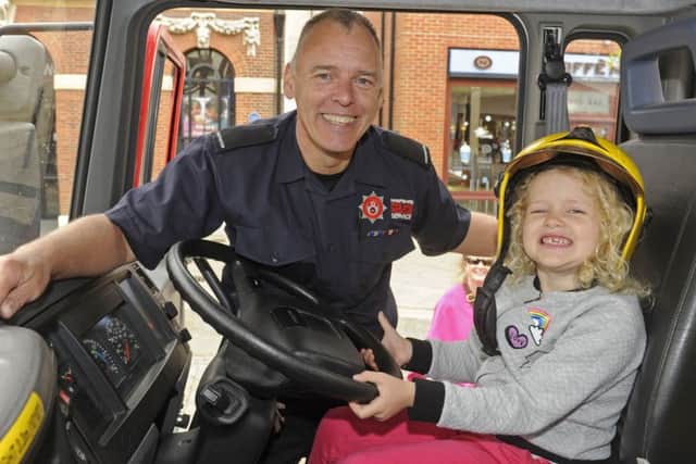 Arabella Leggett (five), from Fareham with firefighter Shaun Grady at the firefighters' event      
Picture Ian Hargreaves  (170625-1)