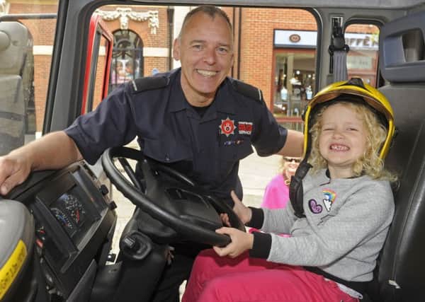Arabella Leggett (five), from Fareham with firefighter Shaun Grady at the firefighters' event      
Picture Ian Hargreaves  (170625-1)