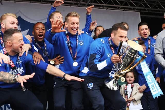 Michael Doyle lifts the League Two trophy. Picture: Joe Pepler