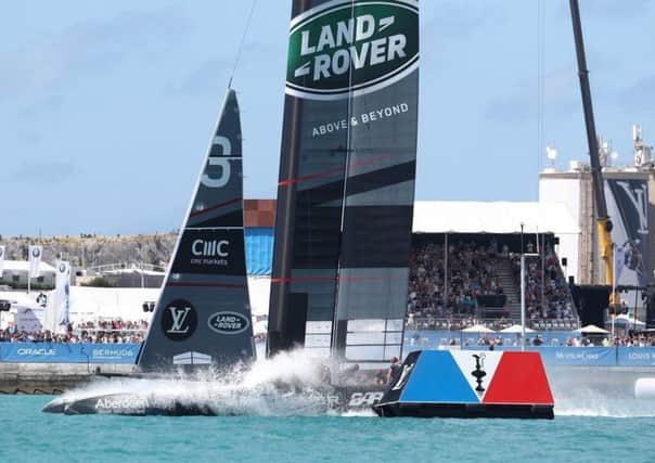 Land Rover BAR pass the finishing line in their victory against team Artemis.  Photo Credit: Gilles Martin-Raget/ America's Cup
