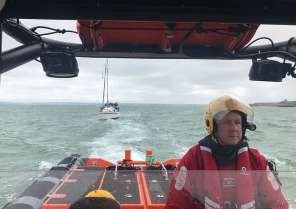 Gafirs senior helm Brian Pack towing a 28ft stricken yacht to safety  after it lost power in the Solent. Picture: Gafirs.