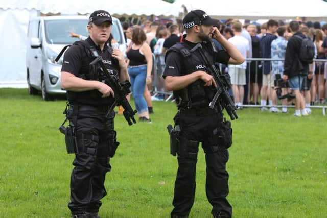 Armed police guard the Mutiny festival at King George V playing field in Portsmouth