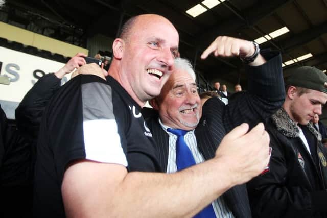 Paul Cook, left, and chairman Iain McInnes celebrate Pompey's promotion at Meadow Lane Picture: Joe Pepler