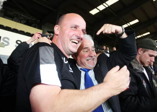 Paul Cook, left, and chairman Iain McInnes celebrate Pompey's promotion at Meadow Lane Picture: Joe Pepler