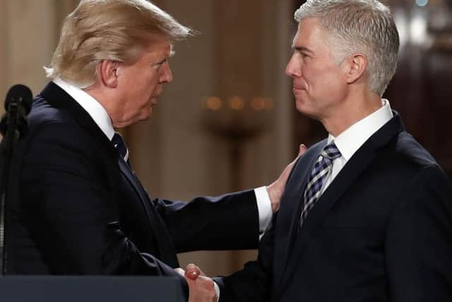 President Donald Trump shakes hands with 10th US Circuit Court of Appeals Judge Neil Gorsuchce  Picture: AP/Carolyn Kaster