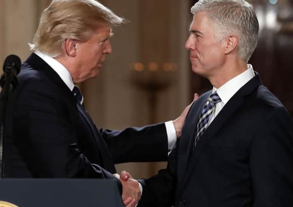 President Donald Trump shakes hands with 10th US Circuit Court of Appeals Judge Neil Gorsuchce  Picture: AP/Carolyn Kaster