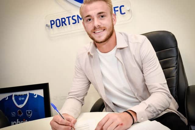 Jack Whatmough signs his new two-year deal at Pompey Picture: Colin Farmery