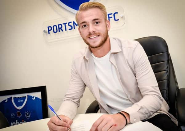 Jack Whatmough signs his new two-year deal at Pompey Picture: Colin Farmery