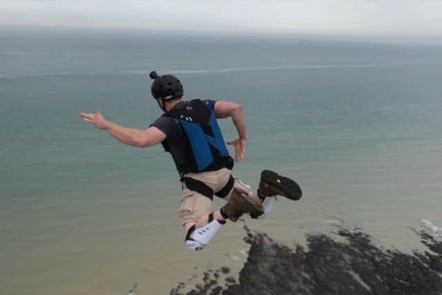 A base jumper leaps from Beachy Head