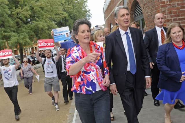 Chancellor Phillip Hammond visits Old Portsmouth with Flick Drummond (left) and Donna Jones (right). In the background are Labour supporters who protested his visit loudly. 
Picture Ian Hargreaves  (170628-1)