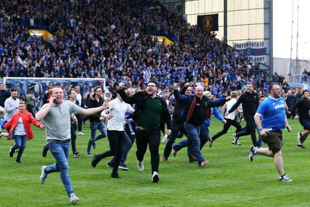 Pompey fans celebrate winning the League Two title. Picture: Joe Pepler