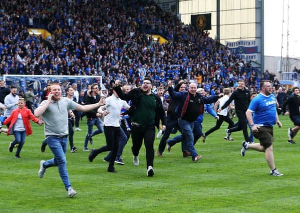 Pompey fans celebrate winning the League Two title. Picture: Joe Pepler