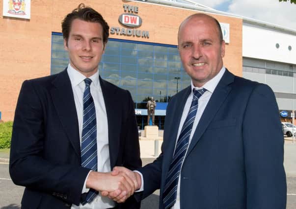 Paul Cook, right, is welcomed to Wigan Athletic by Latics chairman David Sharpe