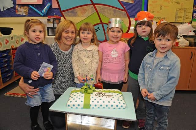 Nursery manager Shirley Faichen with children celebrating a successful Ofsted. Shirley and her team are now fundraising to help pay for the move to bigger premises