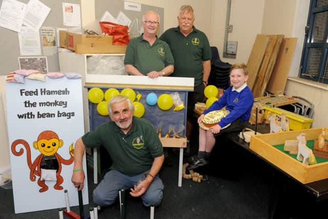Charles Coe, five, with members of Havant Mens Shed who made games for a summer fair