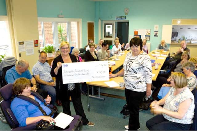 Members of Writers of Lovedean presenting the cheque to Portsmouth MS Society