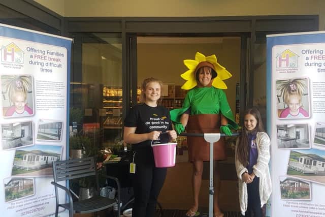 Hannahs Holiday Home founder Pam Marshall dressed as a sunflower while raising awareness of the charity outside M&S, Waterlooville. She is supported by Amy Tucker, left, and Alise Pettitt