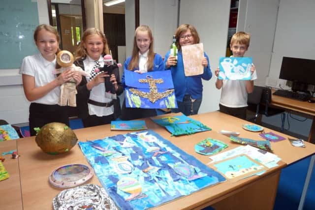 Pupils from Gomer Junior School with the artwork they submitted for the UNDERWATER 2017 exhibition, and, left, a display at the Diving Museum