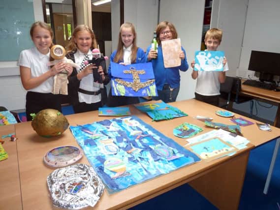 Pupils from Gomer Junior School with the artwork they submitted for the UNDERWATER 2017 exhibition, and, left, a display at the Diving Museum