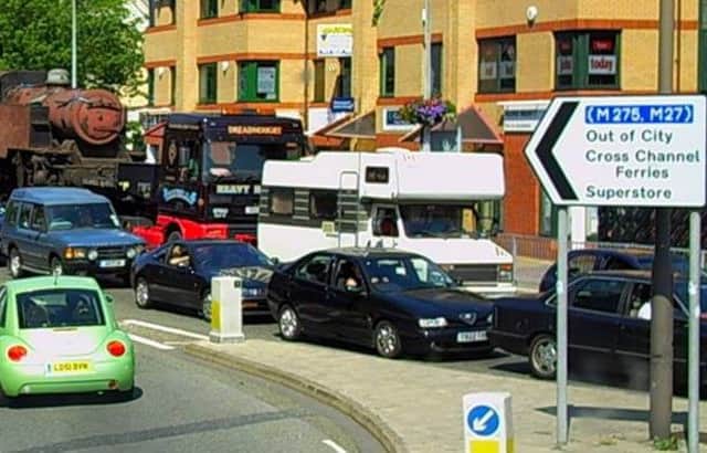 Nothing changes... a 2006 traffic jam in Commercial Road, Portsmouth, with a steam engine giving drivers something different to ponder while they wait.