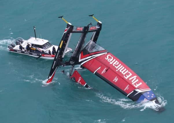 Emirates Team New Zealand capsized against Land Rover BAR.  Picture: Gilles Martin-Raget/ America's Cup