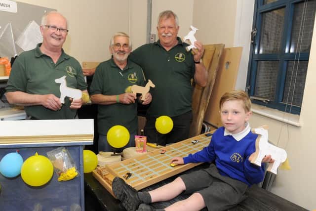 (L-r) Terry Hoy, Frank Rowney and Stewart Burns from Havant Men's Shed with Charles Coe (5) who collected the toys and games on behalf of Compton and Up Marden CofE Primary School. Picture: Sarah Standing (170591-7228)